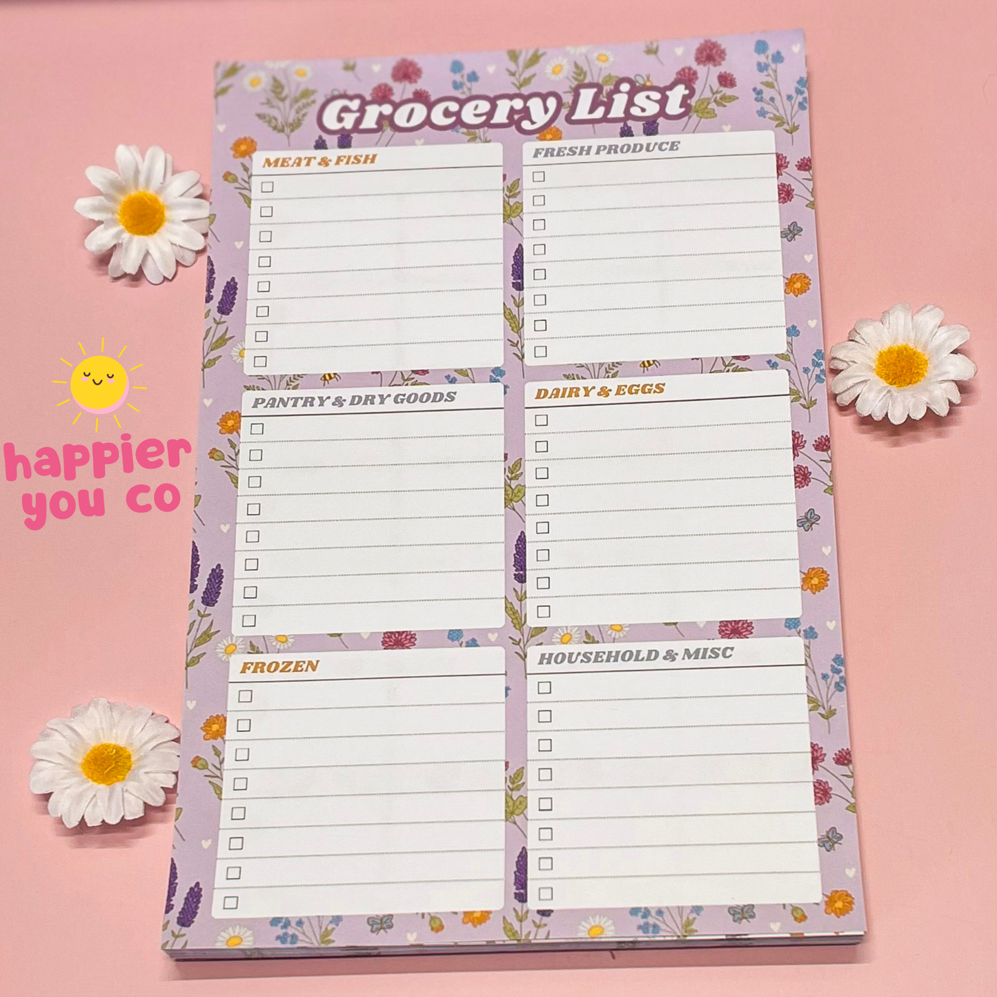 Grocery list notepad with floral design on a pink background