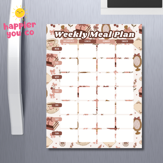 Weekly meal plan chart on a refrigerator with 'happier you co' branding.