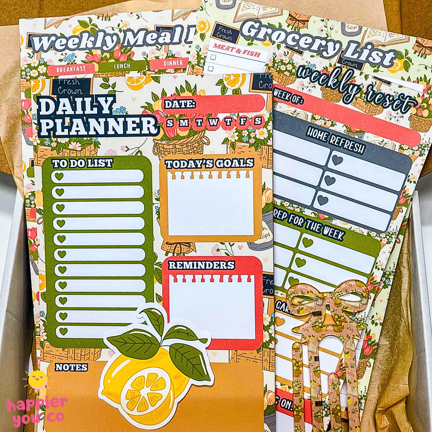 Planner stickers with daily planner, grocery list, and to-do list designs on a cardboard background.