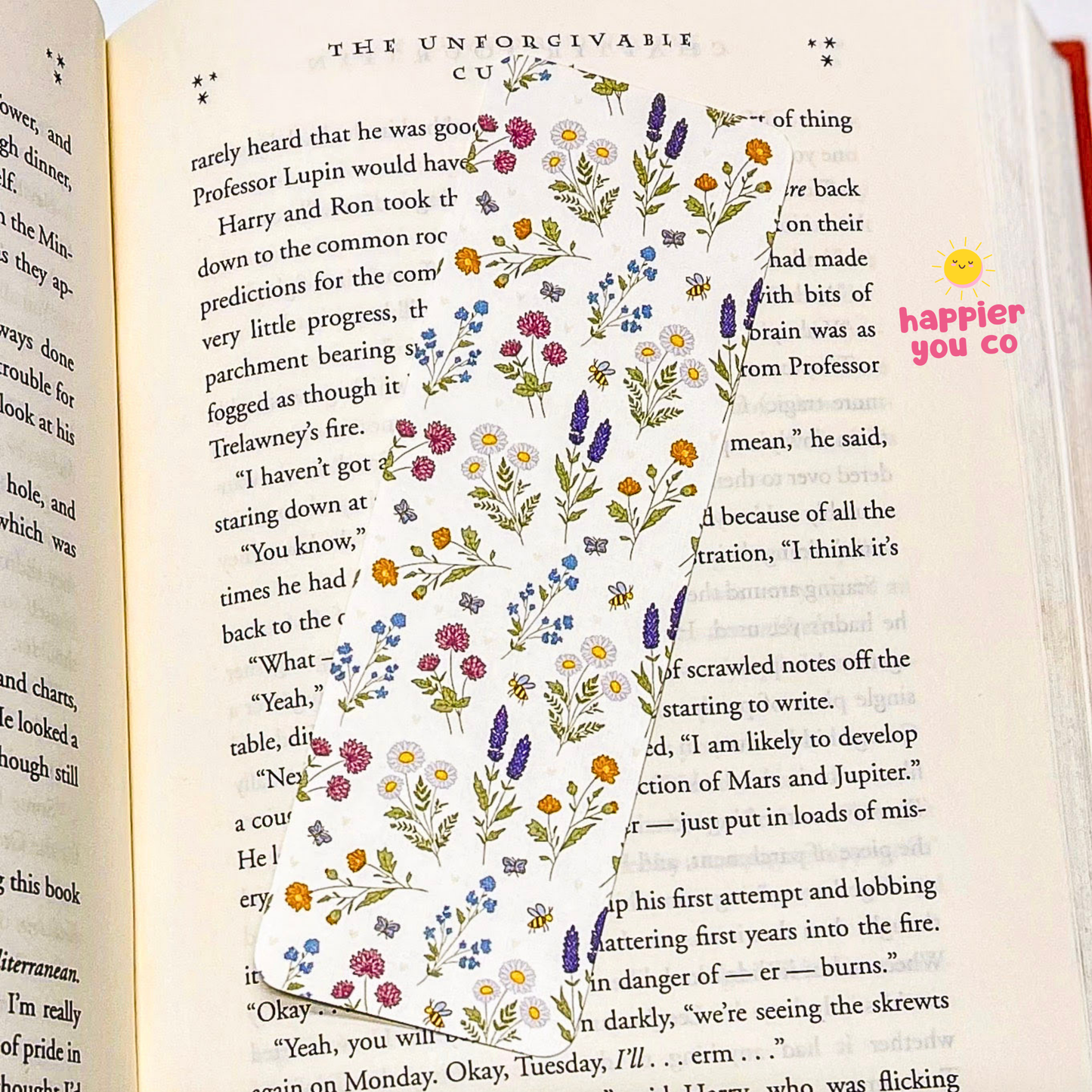 Open book with floral design and 'happier you co' text