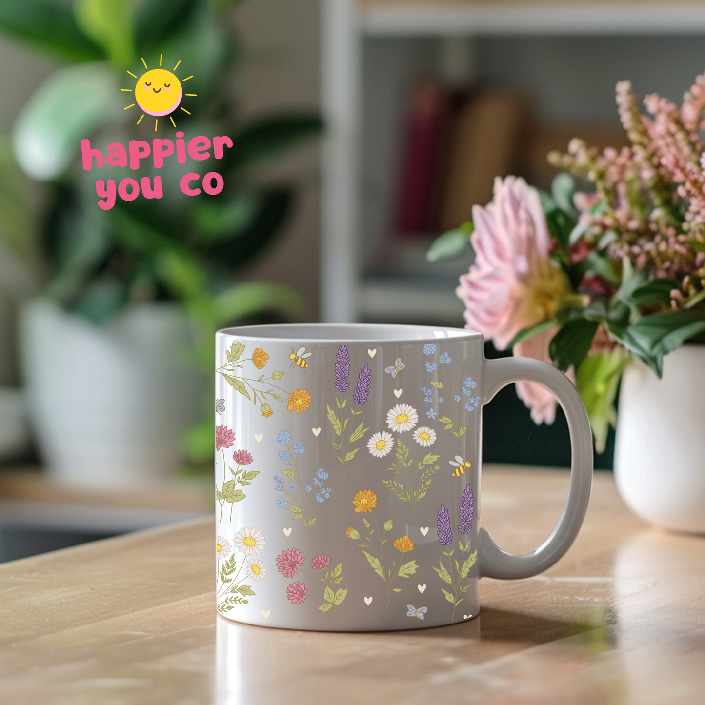 Mug with floral design on a kitchen counter, featuring the text 'happier you co'.