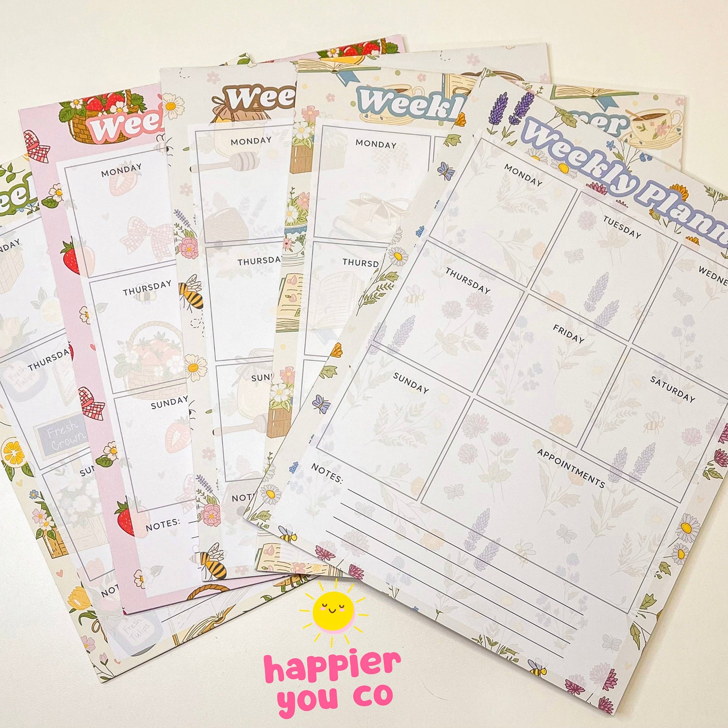 A variety of weekly planner notepads with different colorful designs