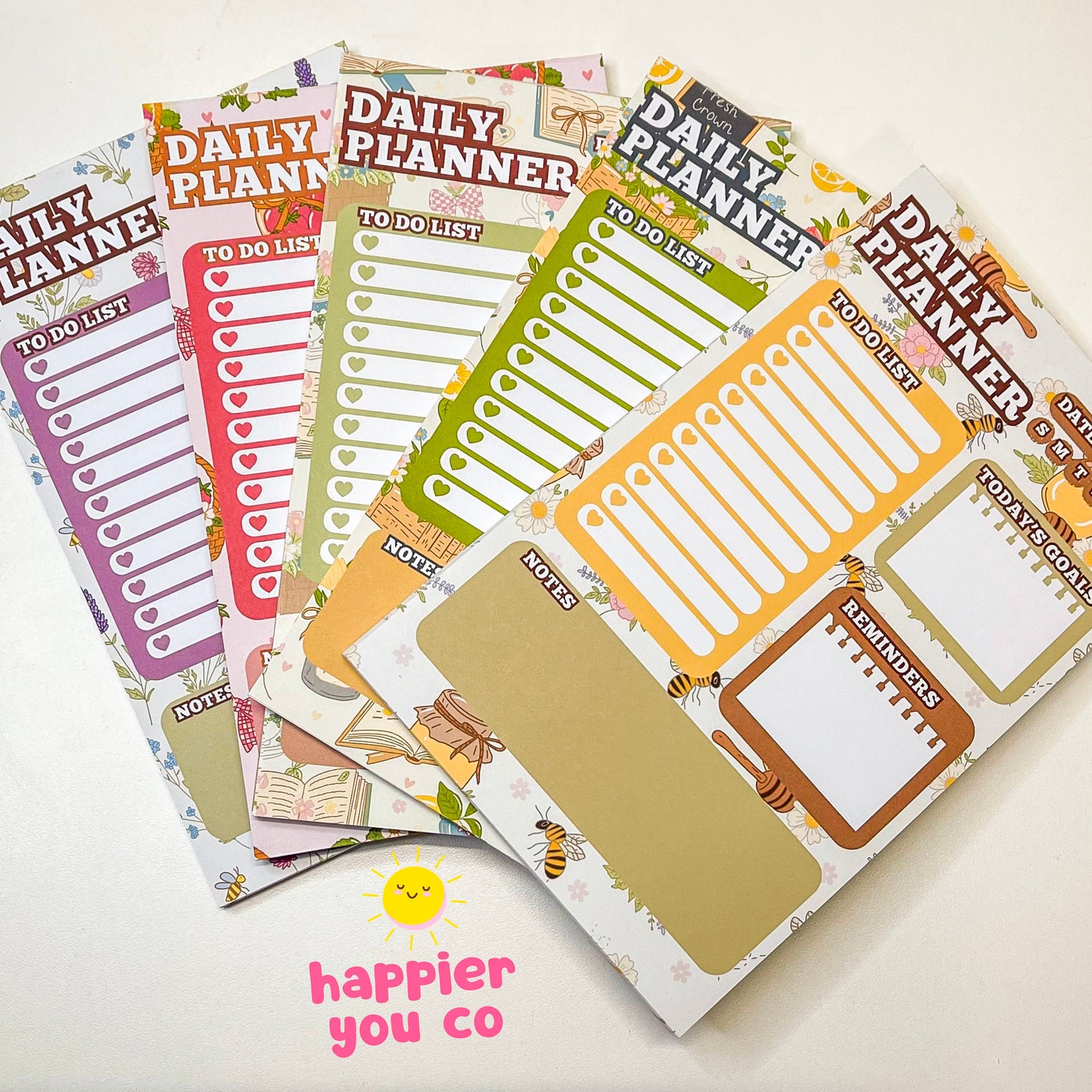 A variety of daily planner notepads with different colorful designs