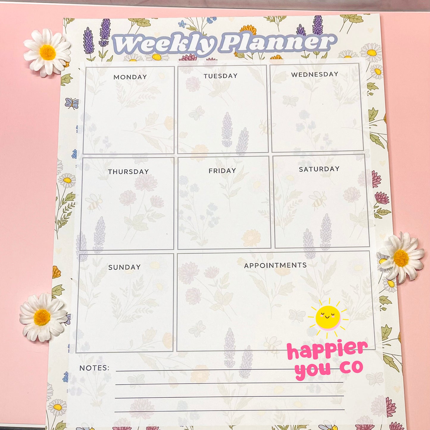Weekly planner with floral design on a pink background
