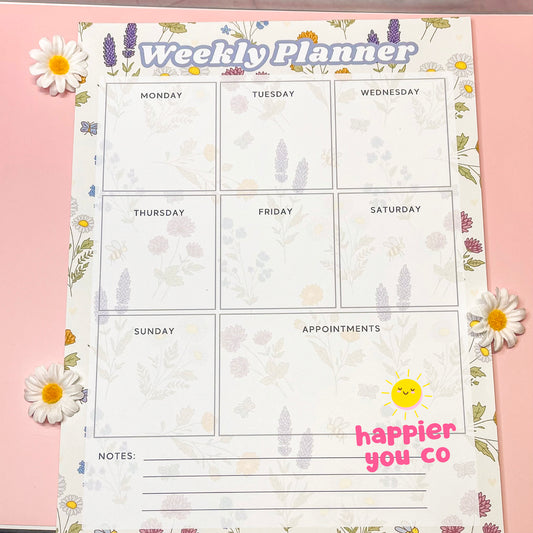 Weekly planner with floral design on a pink background
