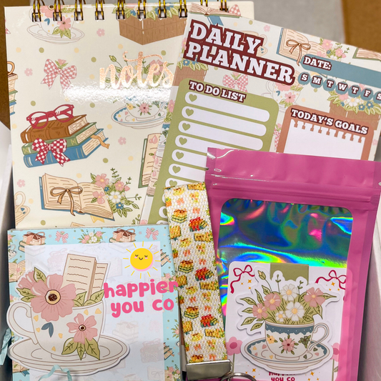 Collection of stationery items including notebooks and a planner with decorative covers.