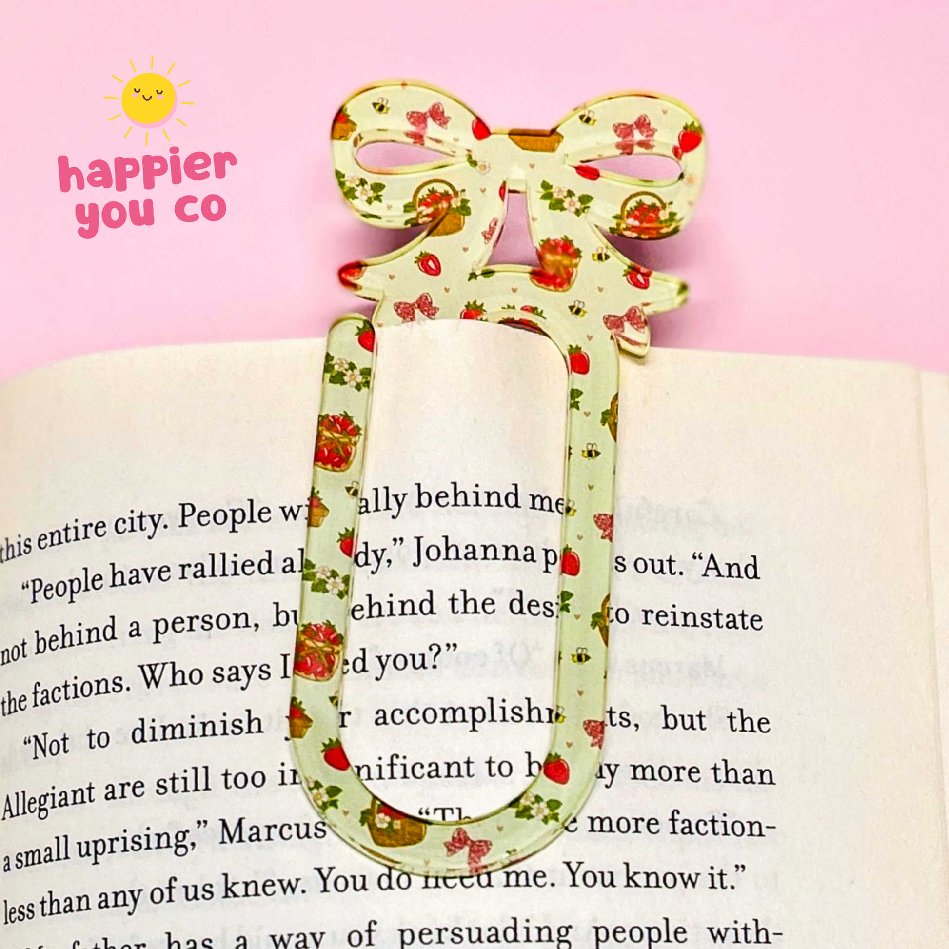 Floral bookmark on a book with 'happier you co' logo in the corner