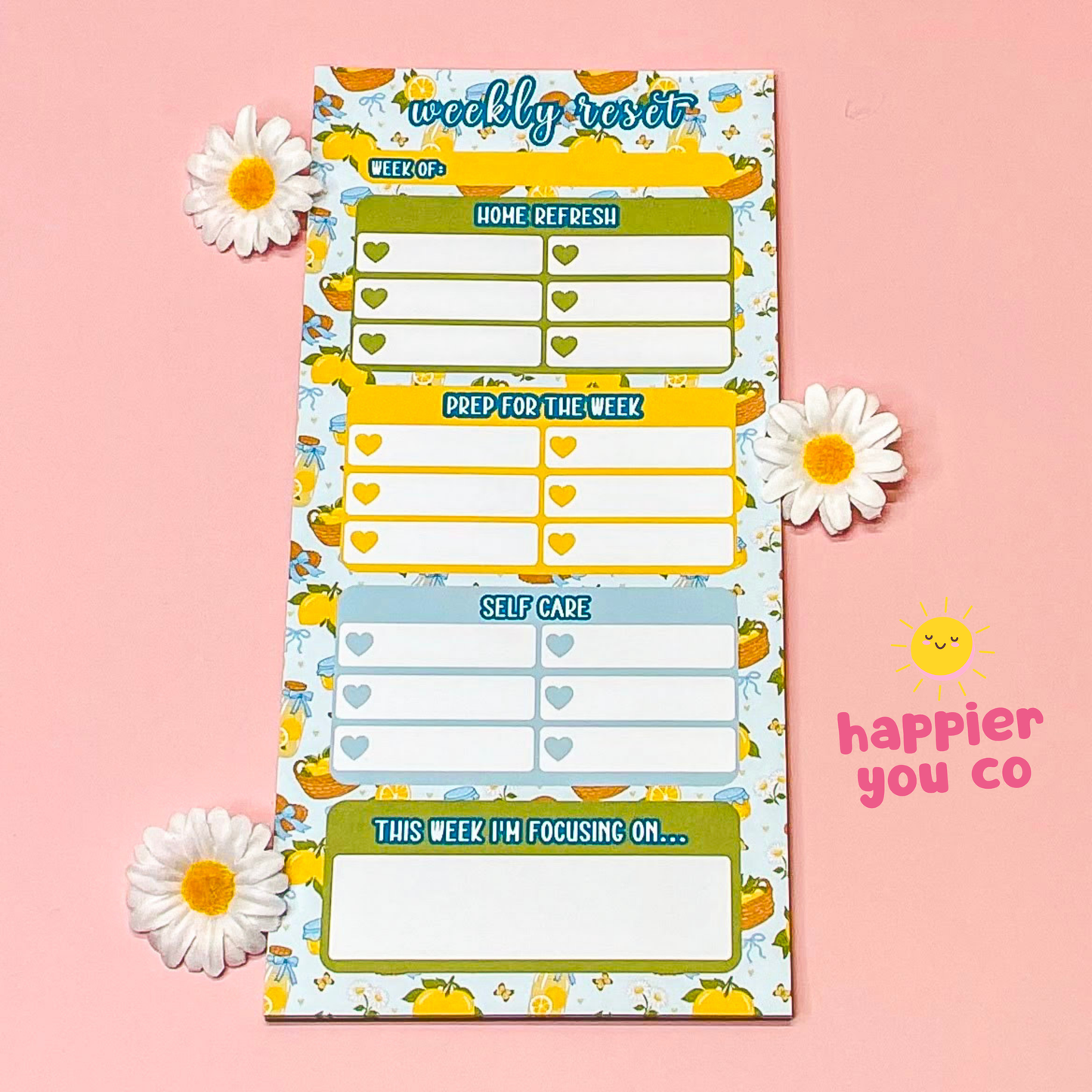 Weekly planner with colorful design on a pink background with flowers and 'happier you co' branding.