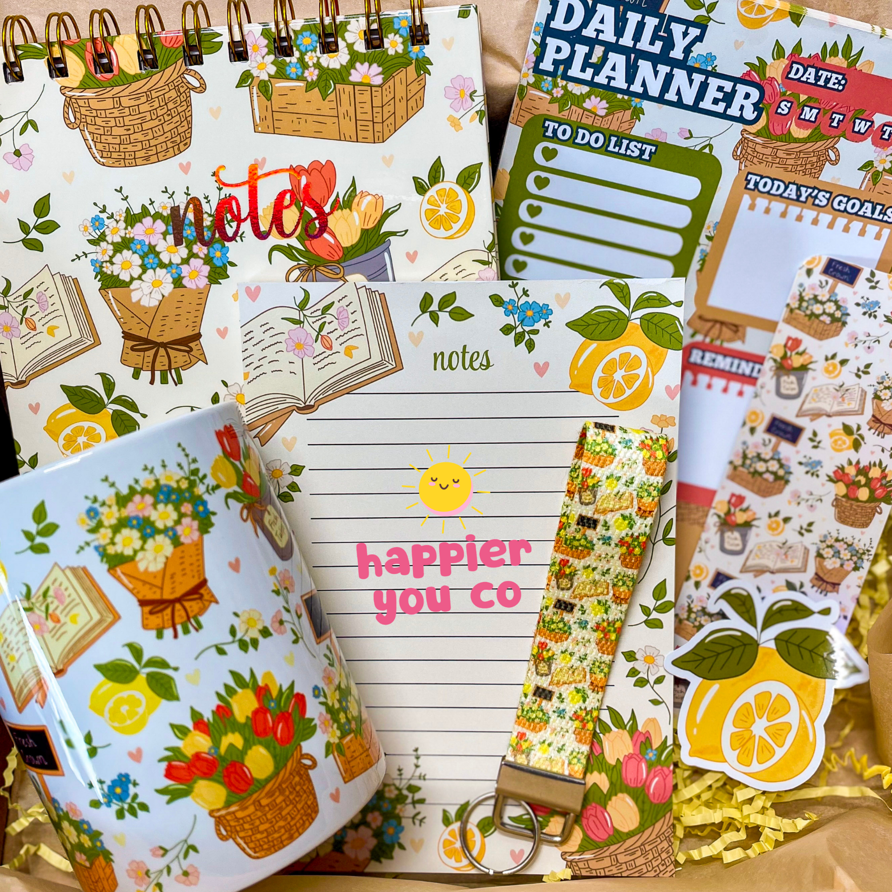 Collection of stationery items including planners, notes, and stickers with floral and lemon designs.