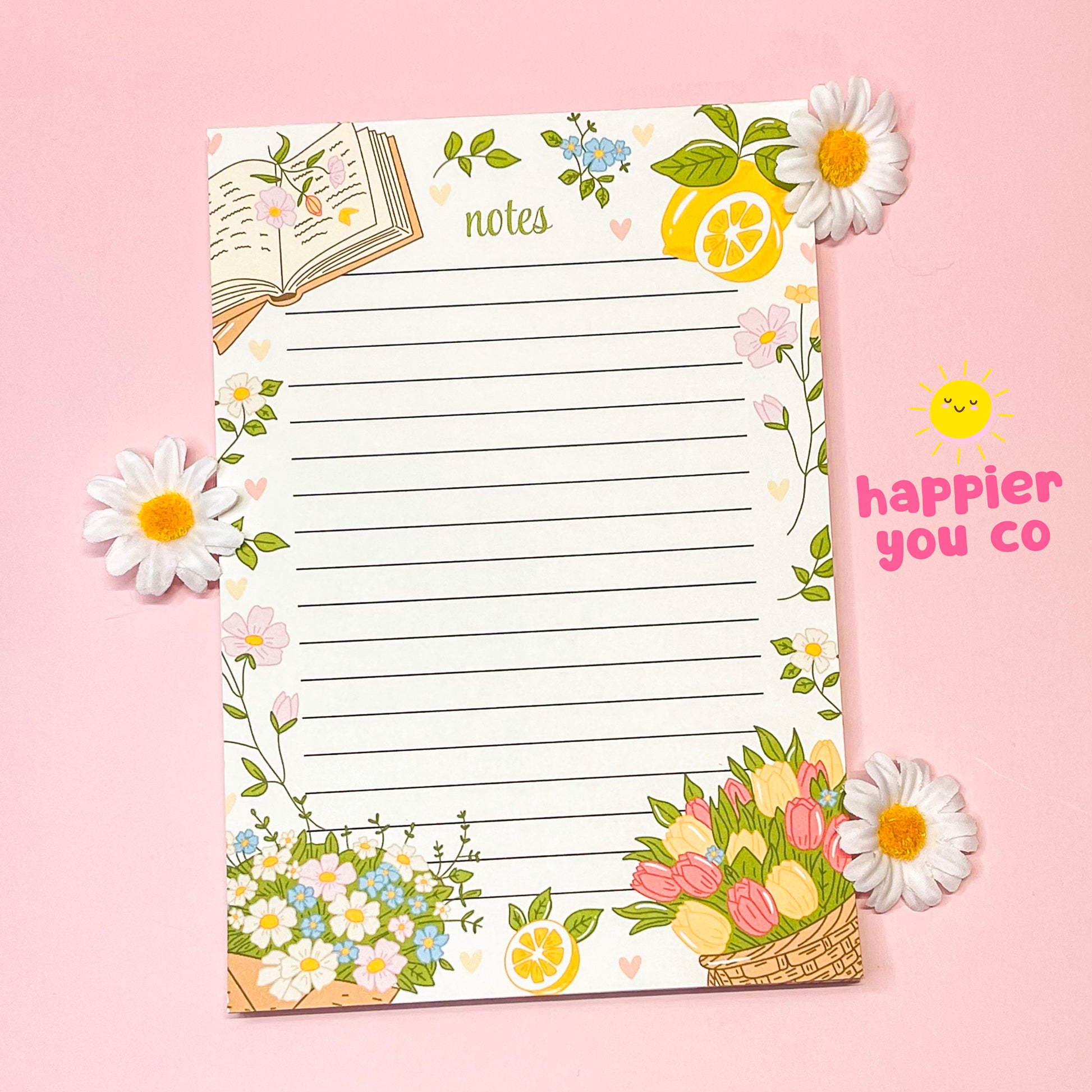 Decorative notepad with floral and lemon designs on a pink background