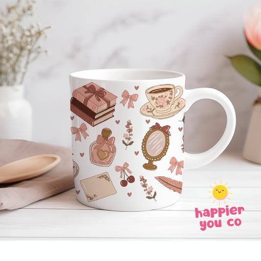 White mug with decorative patterns on a light surface, featuring the 'happier you co' logo.