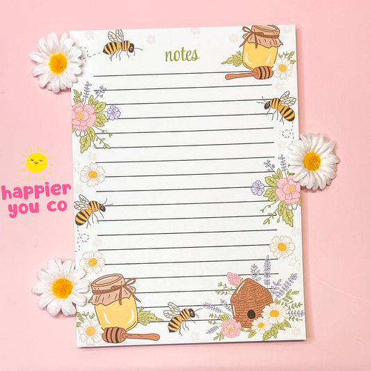 Notebook with bee and honey design on a pink background