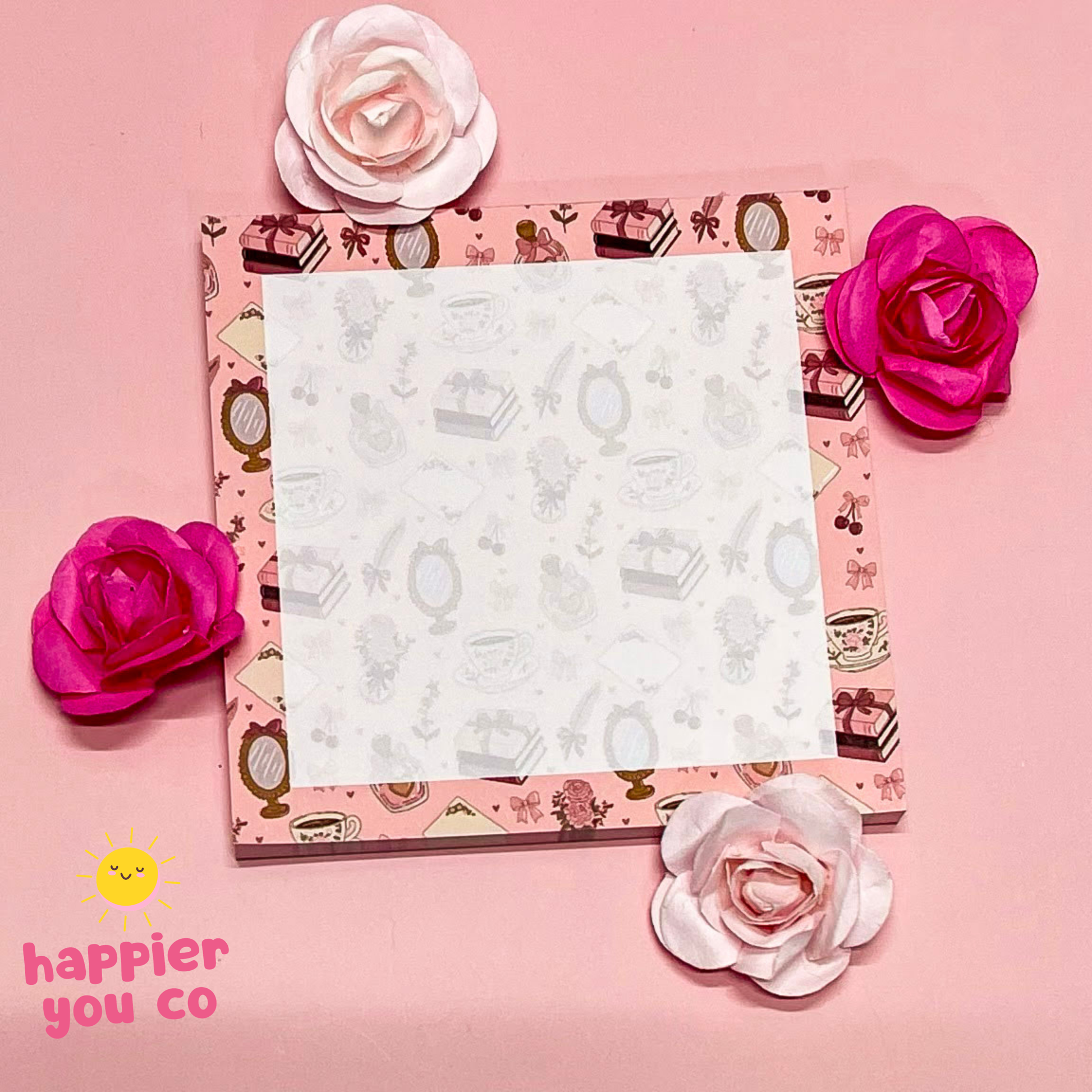 Memo pad with floral design on a pink background, featuring the 'happier you co' brand.