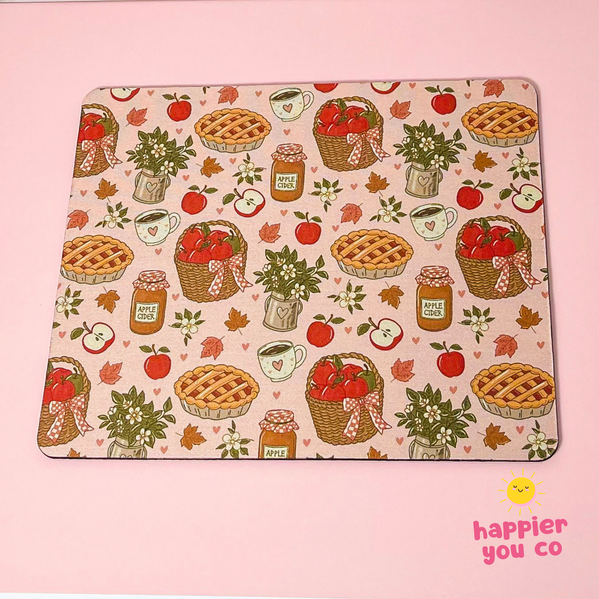 A rectangular mousepad with a vintage autumn apple pie and honeycomb pattern, displayed flat on a solid pink background. The pattern features illustrations of apple pies, baskets of red apples, honeycomb jars, hearts, and leaves on a cream-colored base.