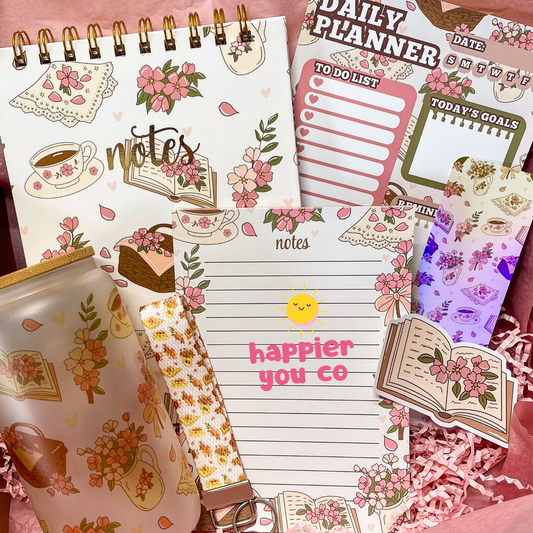 Floral and stationery-themed planner with various decorative elements on a pink background