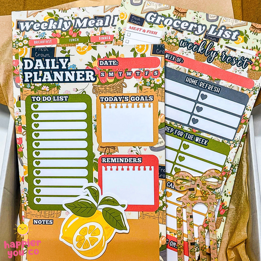 Planner stickers with daily planner, grocery list, and to-do list designs on a cardboard background.