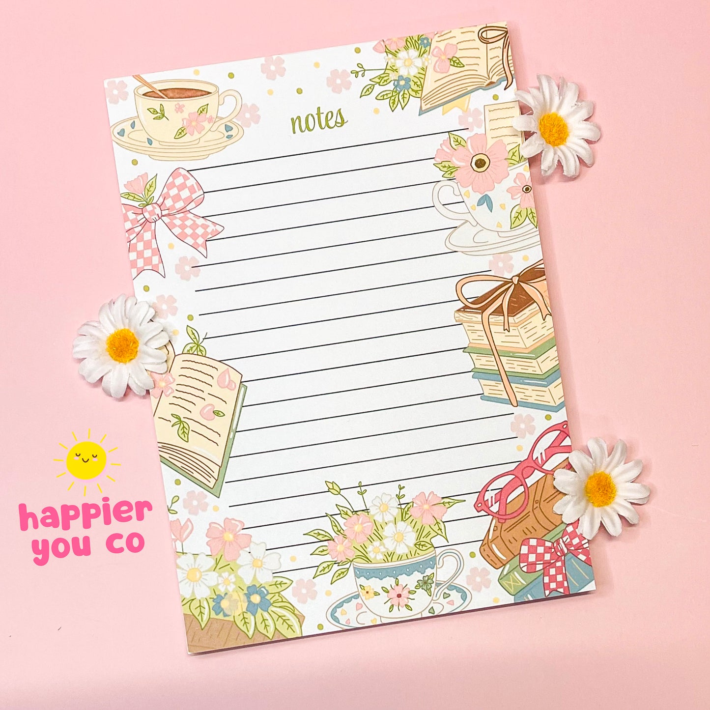Decorative notepad with floral and tea cup designs on a pink background