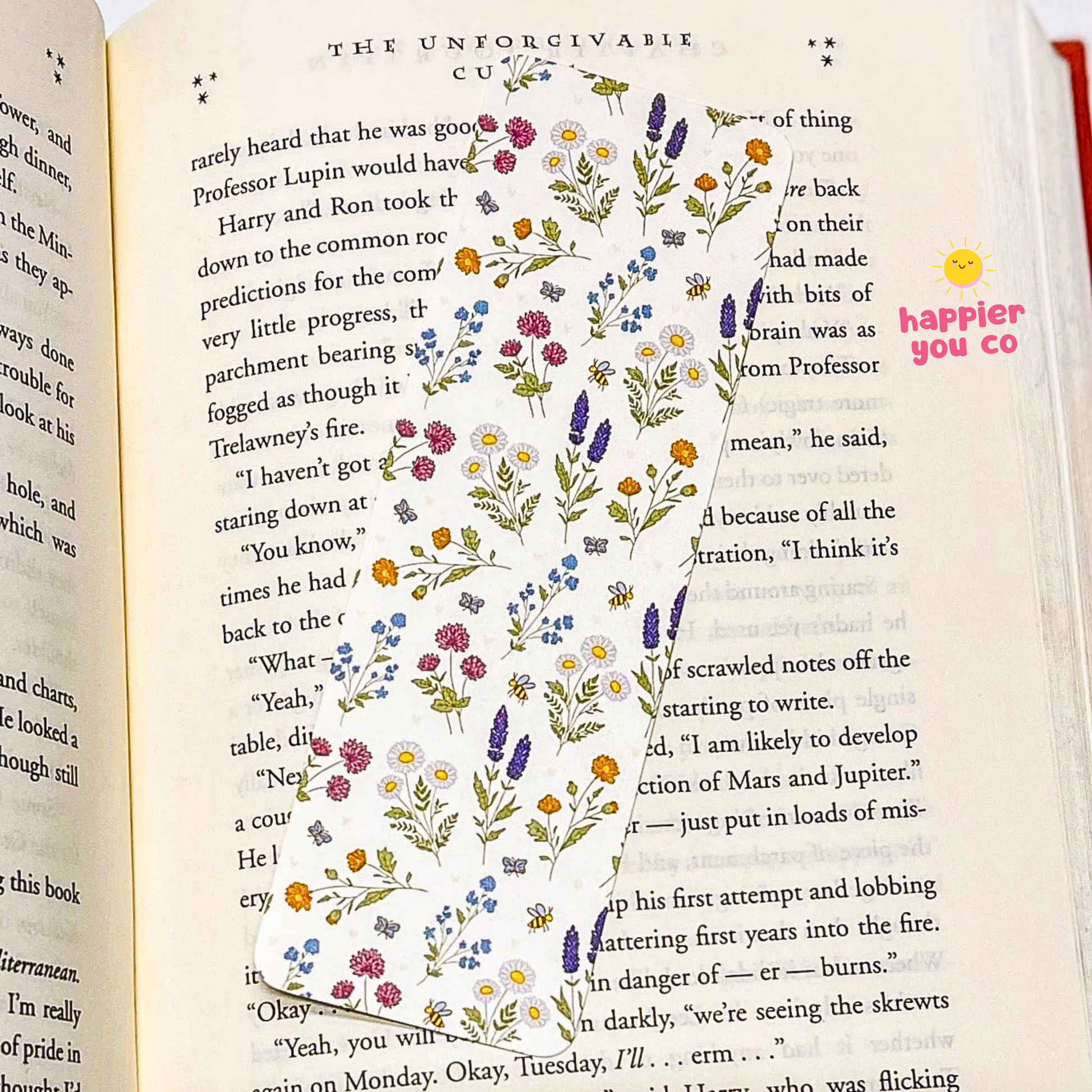 Open book with floral design and 'happier you co' text