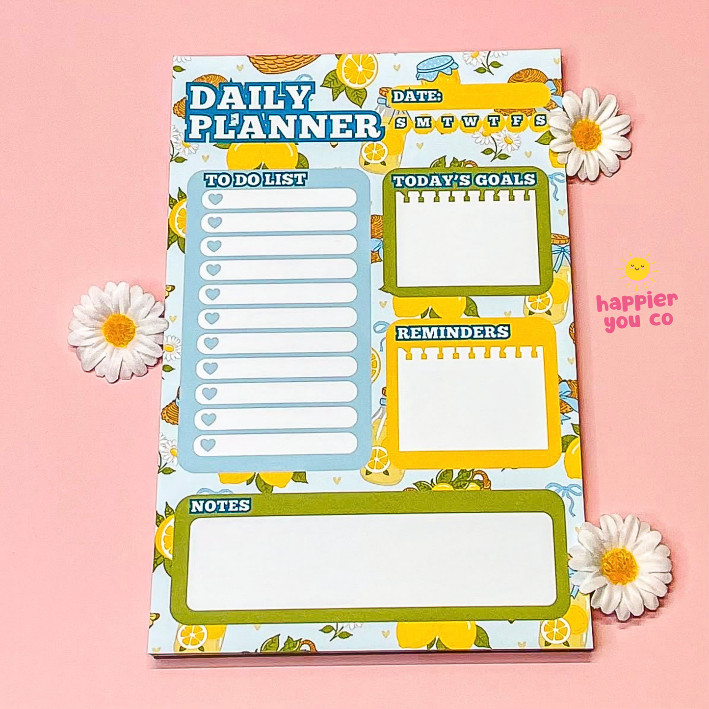 Daily planner with lemon and flower design on a pink background