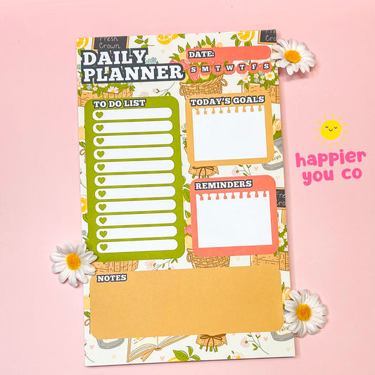Daily planner with various sections on a pink background