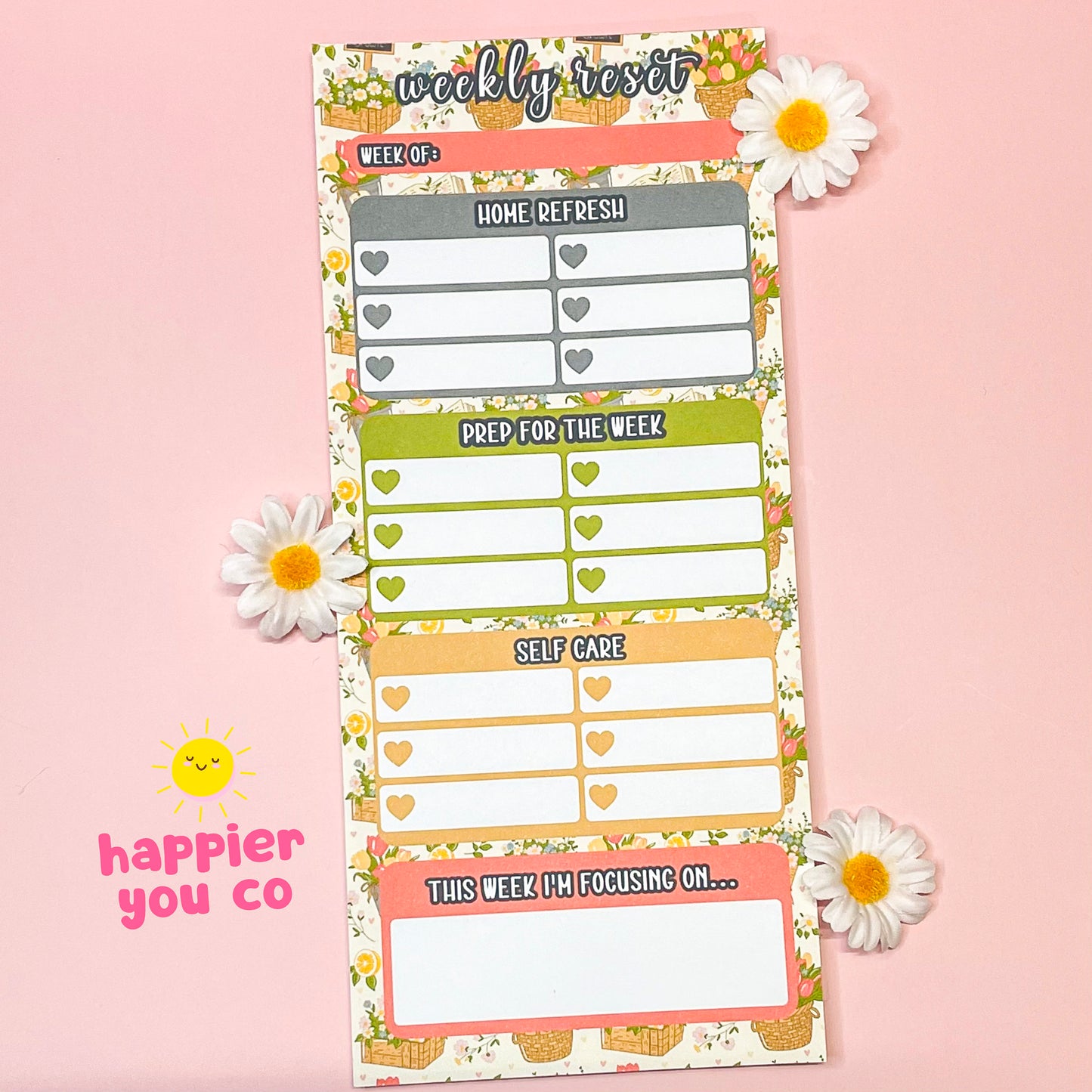 Weekly reset planner with floral design on a pink background