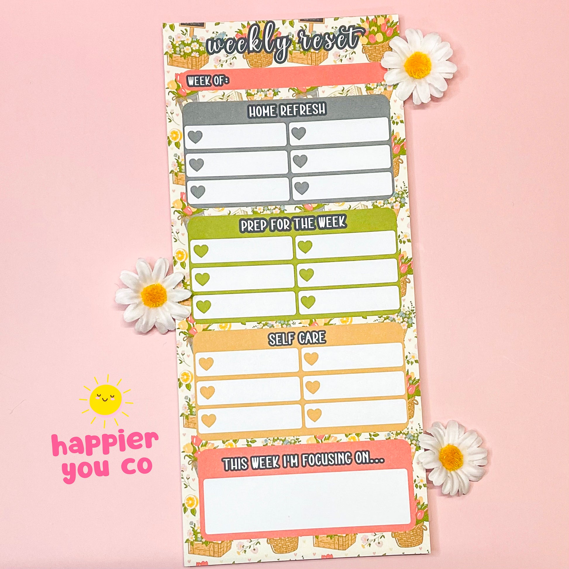Weekly reset planner with floral design on a pink background
