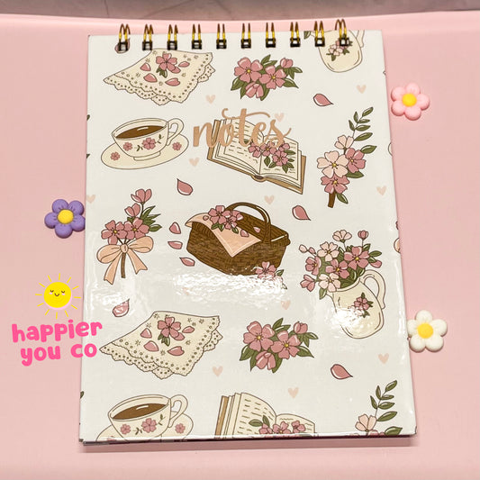 Decorative notebook with illustrations on a pink background