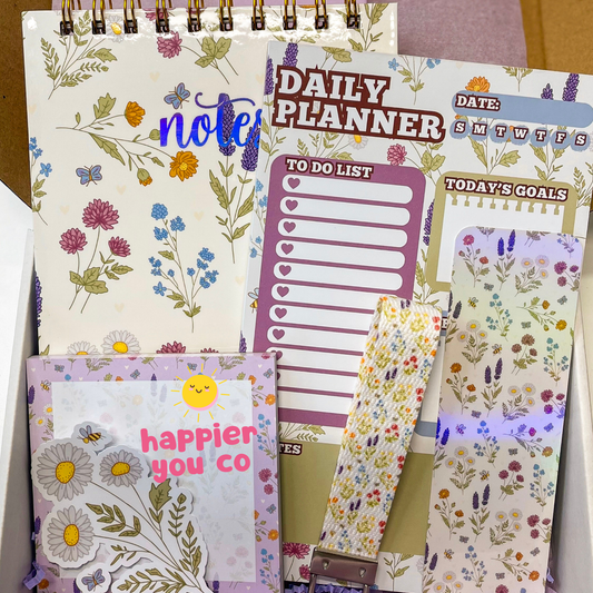 Notebook with floral design, 'Daily Planner' with to-do list and goals, and a small pouch with floral pattern.