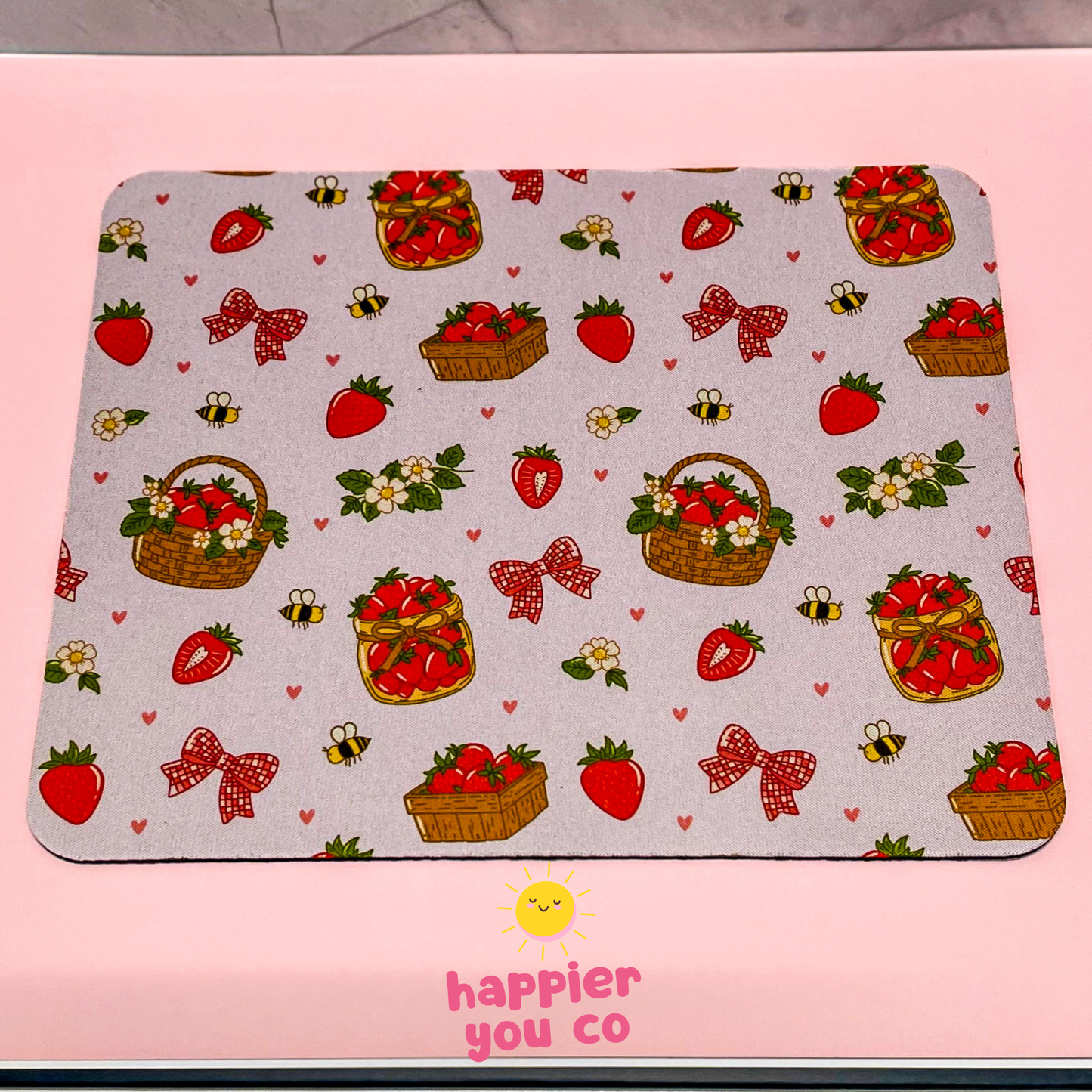 Mouse pad with strawberry and bow pattern on a pink background