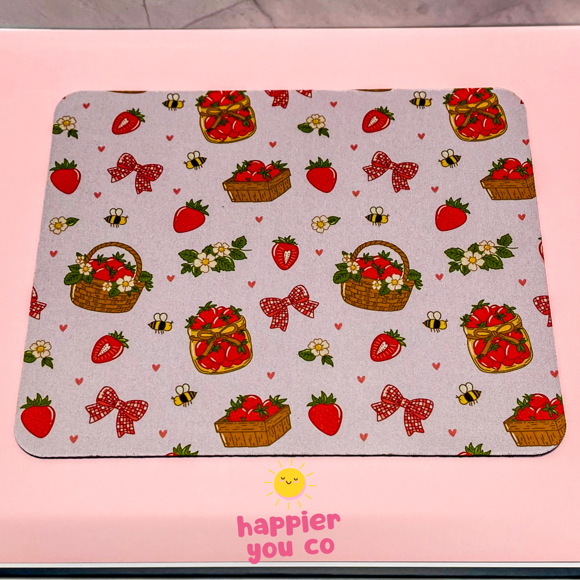 Mouse pad with strawberry and bow pattern on a pink background