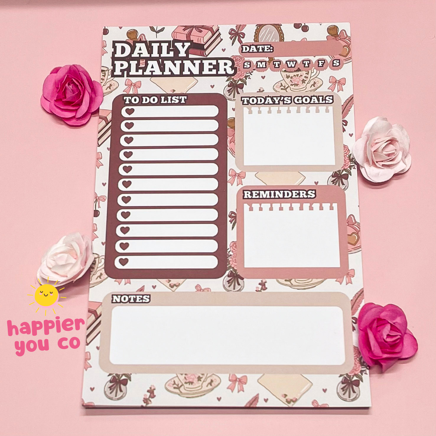 Daily planner with decorative elements on a pink background with flowers