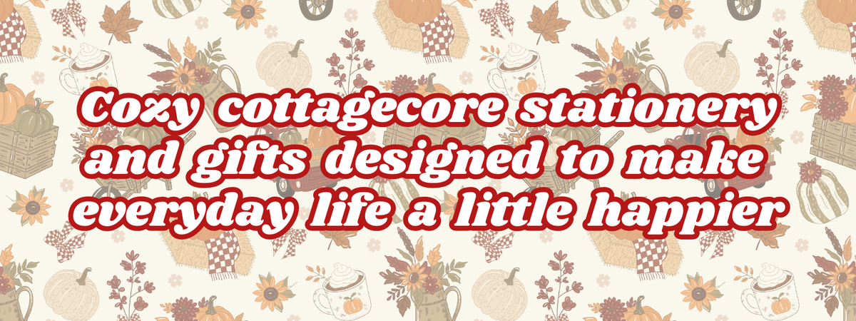 A decorative banner with a repeating autumn pattern of pumpkins, leaves, and floral motifs on a cream background, overlaid with large red text reading, 'Cozy cottagecore stationery and gifts designed to make everyday life a little happier.'.