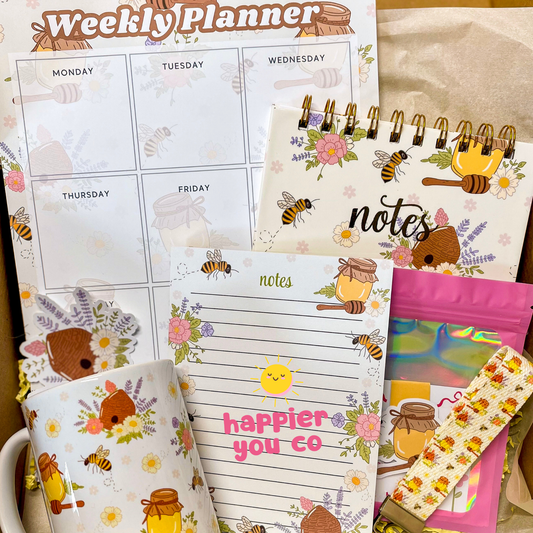 Weekly planner and stationery items with honeybee and floral designs.