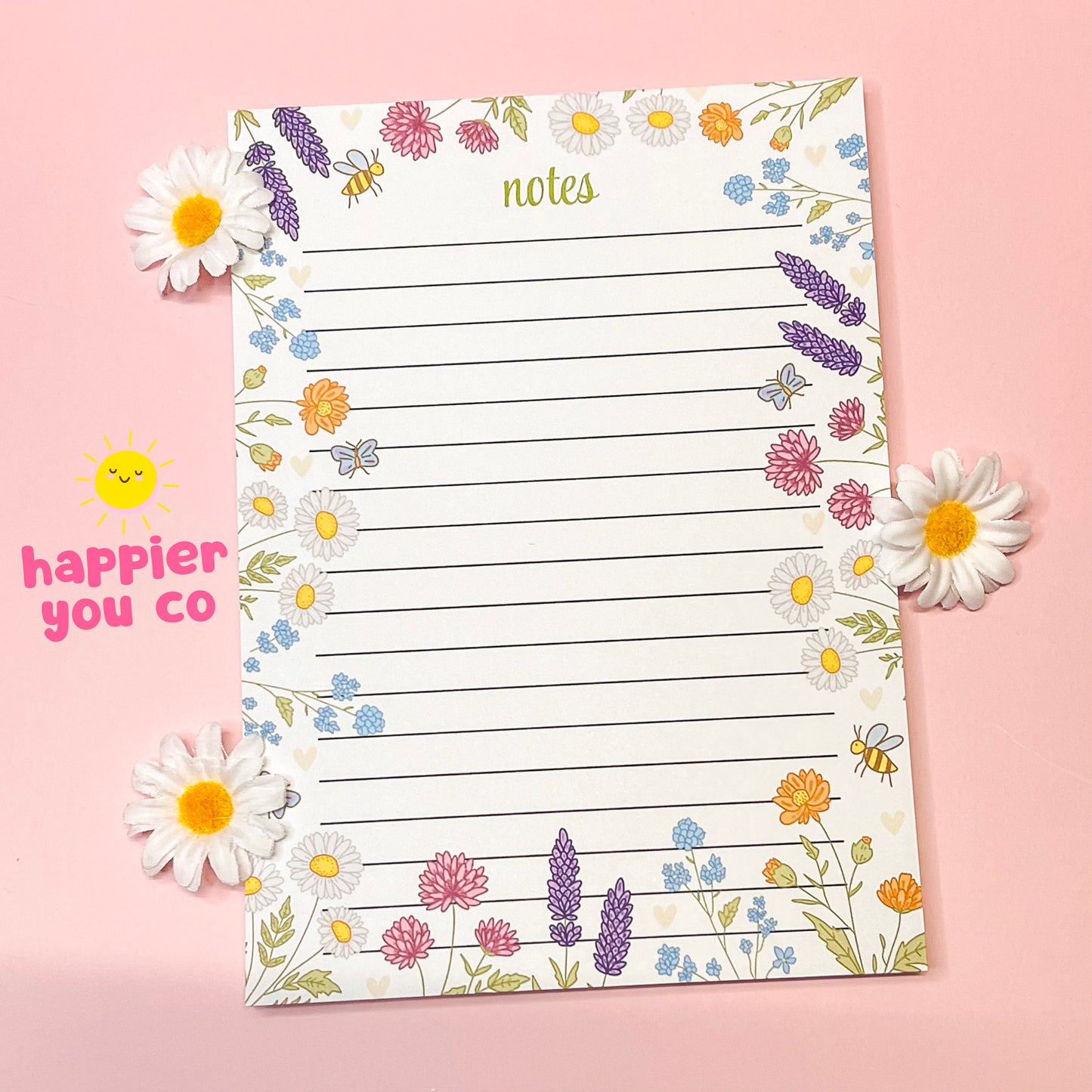 Floral-themed notepad with decorative elements on a pink background