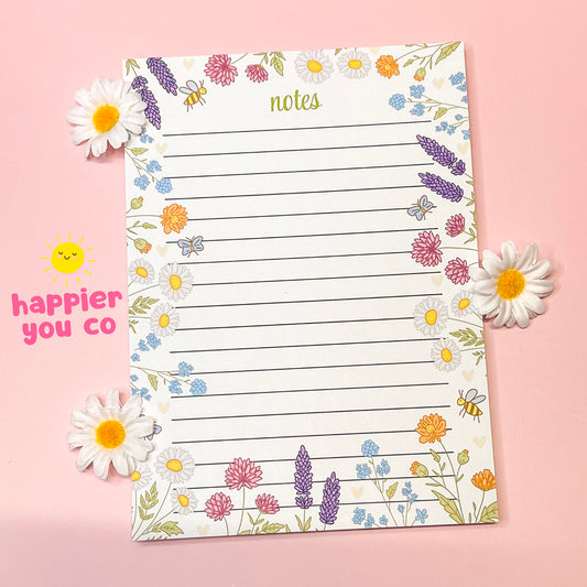 Floral-themed notepad with decorative elements on a pink background