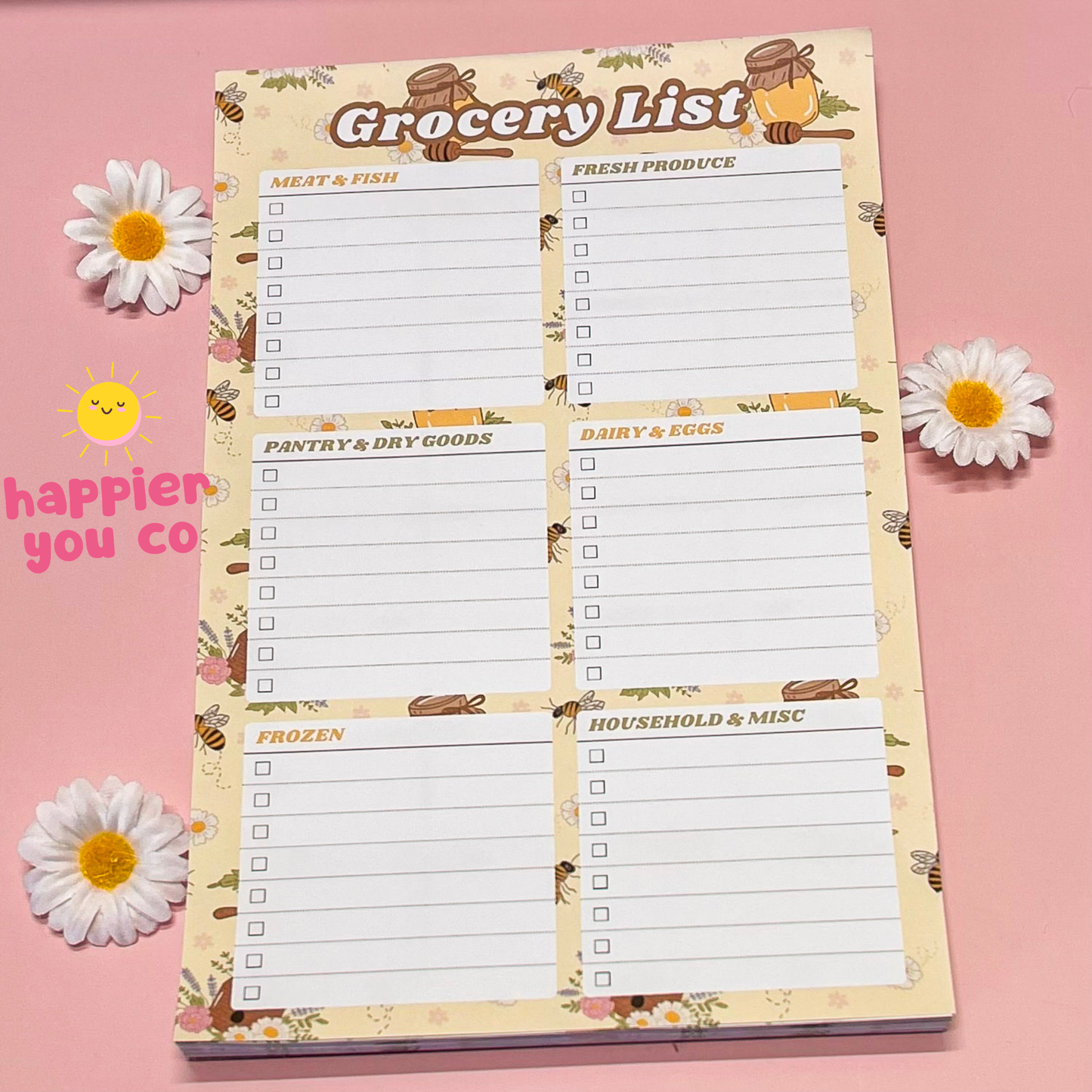Grocery list notepad with floral design on a pink background