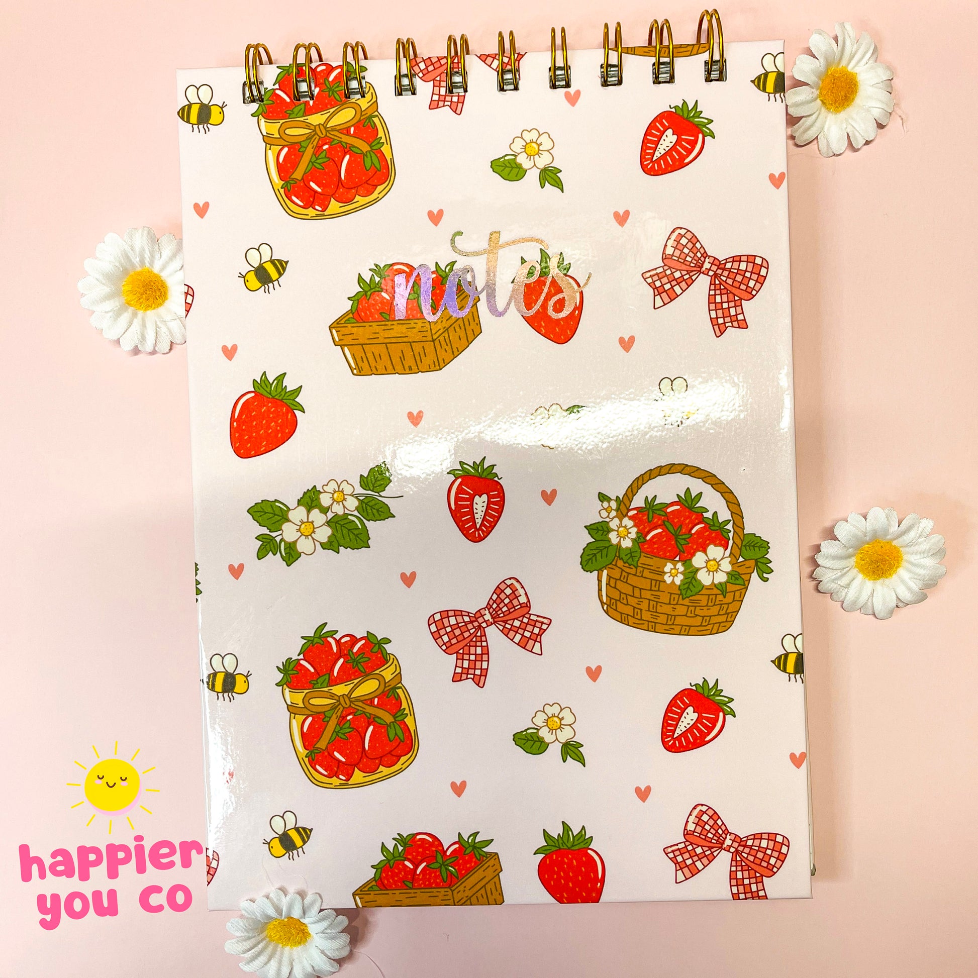 Notebook with strawberry and basket design on a pink background