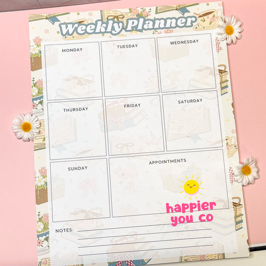 Weekly planner sheet with a bookish spring floral background with 'happier you co' branding on a pink background