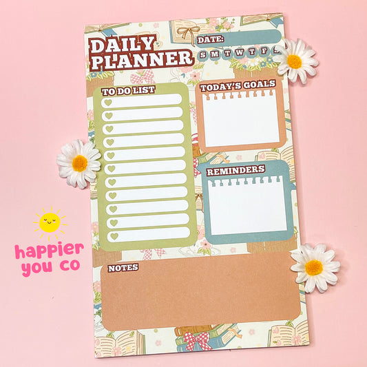 Daily planner sheet with various sections on a pink background with flowers.