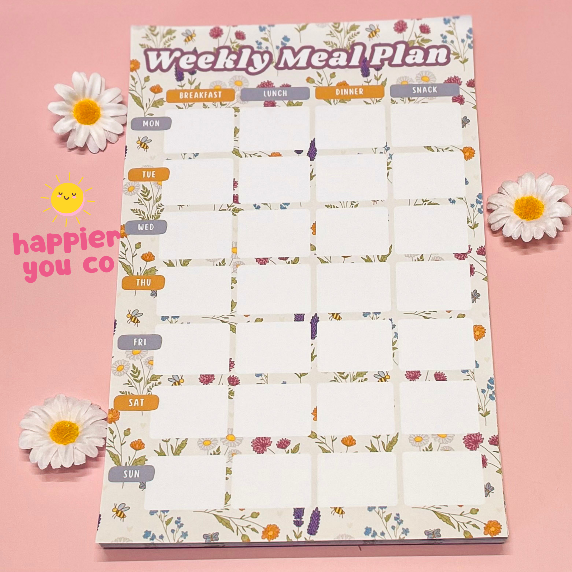 Weekly meal plan chart with floral design on a pink background