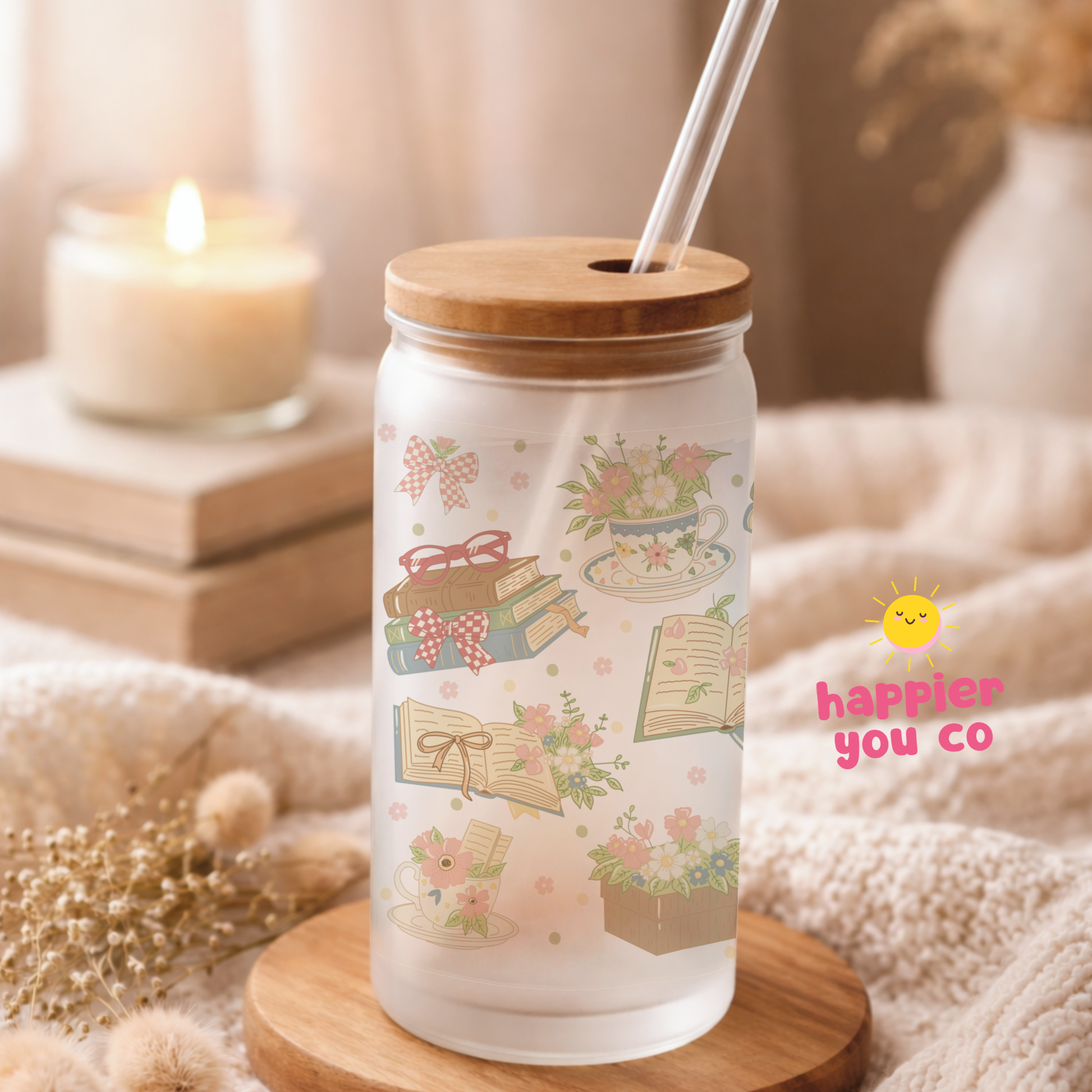 Glass tumbler with wooden lid and straw on a wooden coaster, surrounded by decorative items.